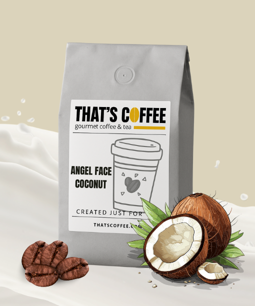 A gray bag of Angel Face Coconut Flavored Coffee Beans is displayed next to coconut-flavored beans and a halved coconut, with a splash of milk in the background.