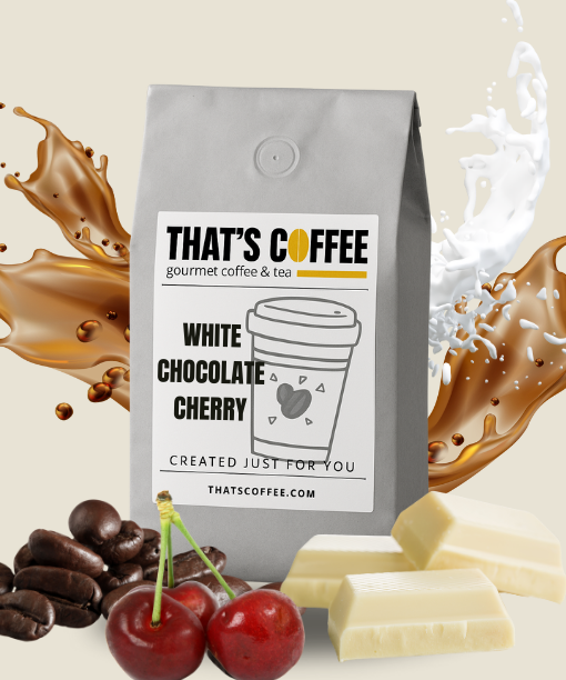 A bag of THAT'S COFFEE White Chocolate Cherry coffee is surrounded by coffee beans, cherries, white chocolate, and splashes of milk and coffee.